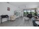 Bright living room featuring wood-look flooring, comfortable seating, and large windows with a picturesque backyard view at 3051 Francoa Dr, Odessa, FL 33556