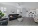 Open concept living room with tile flooring, plantation shutters, ceiling fan and an eat-in kitchen in the background at 3051 Francoa Dr, Odessa, FL 33556