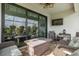 Relaxing screened patio features a ceiling fan, tv, and a fire pit table for outdoor entertaining at 3051 Francoa Dr, Odessa, FL 33556