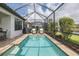 Covered swimming pool with patio, outdoor seating, and a grill at 3051 Francoa Dr, Odessa, FL 33556