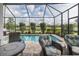 Screened-in pool area with beautiful landscaping and outdoor seating at 3051 Francoa Dr, Odessa, FL 33556