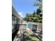 The partially fenced pool area, and wooden privacy fence provides security and seclusion at 3304 Honeymoon Ln, Holiday, FL 34691