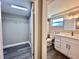 Updated bathroom with white vanity, drawers, and open door to closet at 3304 Honeymoon Ln, Holiday, FL 34691