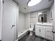 Bathroom features a walk-in shower, modern vanity, great lighting, and luxury vinyl flooring at 3304 Honeymoon Ln, Holiday, FL 34691