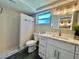 Bathroom featuring a shower, toilet, and sink with a window at 3304 Honeymoon Ln, Holiday, FL 34691