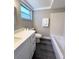 Clean and updated bathroom featuring a modern vanity, sleek fixtures, and a tiled shower at 3304 Honeymoon Ln, Holiday, FL 34691