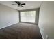 A bright bedroom featuring neutral walls, carpet and a window at 3304 Honeymoon Ln, Holiday, FL 34691