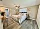 Comfortable bedroom featuring a ceiling fan and natural light at 3304 Honeymoon Ln, Holiday, FL 34691