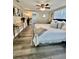 Spacious bedroom with ceiling fan, desk, and wood-look flooring at 3304 Honeymoon Ln, Holiday, FL 34691