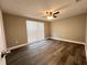 This bedroom features hard surface floors, neutral walls and large window with a view at 3304 Honeymoon Ln, Holiday, FL 34691