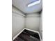 Walk-in closet with wire shelving and wood-look floors at 3304 Honeymoon Ln, Holiday, FL 34691