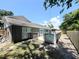 Exterior view of house showing backyard, pool, and fenced yard, offering privacy and outdoor enjoyment at 3304 Honeymoon Ln, Holiday, FL 34691