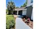 Home's inviting front entrance with lush landscaping and a charming walkway at 3304 Honeymoon Ln, Holiday, FL 34691