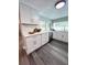 Bright kitchen with modern white cabinetry, stainless steel dishwasher, and ample counter space at 3304 Honeymoon Ln, Holiday, FL 34691