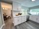 Modern kitchen featuring white cabinets, quartz countertops, and stainless steel appliances at 3304 Honeymoon Ln, Holiday, FL 34691