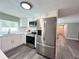 Modern kitchen with stainless steel refrigerator, sleek cabinets, and efficient layout at 3304 Honeymoon Ln, Holiday, FL 34691