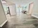 Bright living room featuring stylish furniture, wood-look floors, and access to the outdoor pool area at 3304 Honeymoon Ln, Holiday, FL 34691