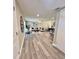 Cozy open-concept living room with modern decor and wood-look flooring at 3304 Honeymoon Ln, Holiday, FL 34691