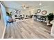 Open-concept living room with stylish decor, comfortable seating, and wood-look floors at 3304 Honeymoon Ln, Holiday, FL 34691
