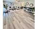 Spacious living room with wood-look flooring, stylish seating, and modern decor at 3304 Honeymoon Ln, Holiday, FL 34691