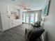 Bright and airy living space with white built-in cabinets and convenient access to the outdoor pool area at 3304 Honeymoon Ln, Holiday, FL 34691