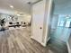 Open living room featuring modern furnishings, wood-look flooring, and a bright atmosphere at 3304 Honeymoon Ln, Holiday, FL 34691