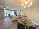Bright living room with large window, stylish furnishings, and modern light fixture at 3304 Honeymoon Ln, Holiday, FL 34691
