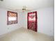 Bedroom features light walls, two windows with decorative curtains, and ceiling fan at 3851 Redwood Dr, Holiday, FL 34691