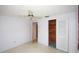 Minimalist bedroom featuring a ceiling fan and built-in closet, perfect for relaxation at 3851 Redwood Dr, Holiday, FL 34691