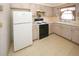 Functional kitchen with updated white refrigerator, black stovetop, and lots of cabinet space at 3851 Redwood Dr, Holiday, FL 34691