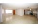 Bright and open living area with connecting kitchen featuring white walls and light flooring at 3851 Redwood Dr, Holiday, FL 34691