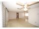 Open living space with decorative wallpaper, fan, and access to other rooms via sliding barn doors at 3851 Redwood Dr, Holiday, FL 34691