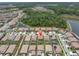 Aerial view of a home nestled in a quiet neighborhood surrounded by beautiful lakes and lush trees at 4056 Burdick Loop, Odessa, FL 33556