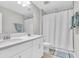 This bathroom features double sinks, a large mirror, tile floors and a shower with a curtain at 4056 Burdick Loop, Odessa, FL 33556