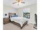 Cozy bedroom featuring neutral walls, ceiling fan, window with blinds, and a comfortable bed at 4056 Burdick Loop, Odessa, FL 33556