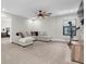 Upstairs bonus room features a neutral colored sectional, large TV and exercise equipment on neutral colored carpet at 4056 Burdick Loop, Odessa, FL 33556