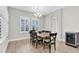 Cozy dining room features stylish chairs, wood table, chandelier, plantation shutters, and wine cooler at 4056 Burdick Loop, Odessa, FL 33556