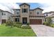 Charming two-story home with a paved driveway, neutral color palette, and a well-maintained lawn at 4056 Burdick Loop, Odessa, FL 33556
