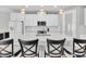 Stylish kitchen with white cabinetry, stainless steel appliances, ample counter space, and bar stool seating at 4056 Burdick Loop, Odessa, FL 33556