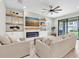 Comfortable living room features built-in fireplace, modern furniture, and sliding glass doors to outdoor patio at 4056 Burdick Loop, Odessa, FL 33556