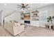 Bright living room features a modern fireplace with floating shelves, a ceiling fan, and a neutral color palette at 4056 Burdick Loop, Odessa, FL 33556