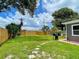 Spacious backyard with lush green grass, a wood fence, and mature trees for privacy at 4057 67Th N Ave, Pinellas Park, FL 33781