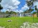 Expansive backyard offering a grill, cornhole game, outdoor seating, and lush green grass at 4057 67Th N Ave, Pinellas Park, FL 33781