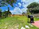 Large backyard featuring a grill, cornhole game, and a well-maintained lawn at 4057 67Th N Ave, Pinellas Park, FL 33781