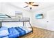 Bright bedroom featuring a bunk bed, wood-look floors, TV and a ceiling fan at 4057 67Th N Ave, Pinellas Park, FL 33781
