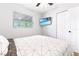 Bright bedroom with a ceiling fan, TV, closet, and a window providing natural light at 4057 67Th N Ave, Pinellas Park, FL 33781