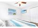 Bright bedroom with a ceiling fan, TV, closet, and natural light at 4057 67Th N Ave, Pinellas Park, FL 33781