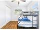Bright bedroom featuring a bunk bed, wood-look flooring, and a closet at 4057 67Th N Ave, Pinellas Park, FL 33781