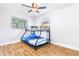 Cozy bedroom with bunk beds, wood-look flooring, and natural light at 4057 67Th N Ave, Pinellas Park, FL 33781