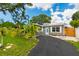 Charming single-story home with a well-manicured lawn, fresh landscaping, and a paved driveway at 4057 67Th N Ave, Pinellas Park, FL 33781